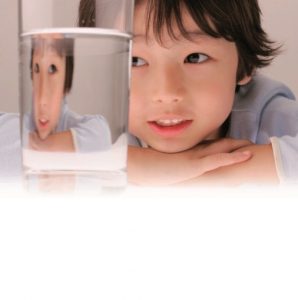 Young Boy Looking at a Glass of Water